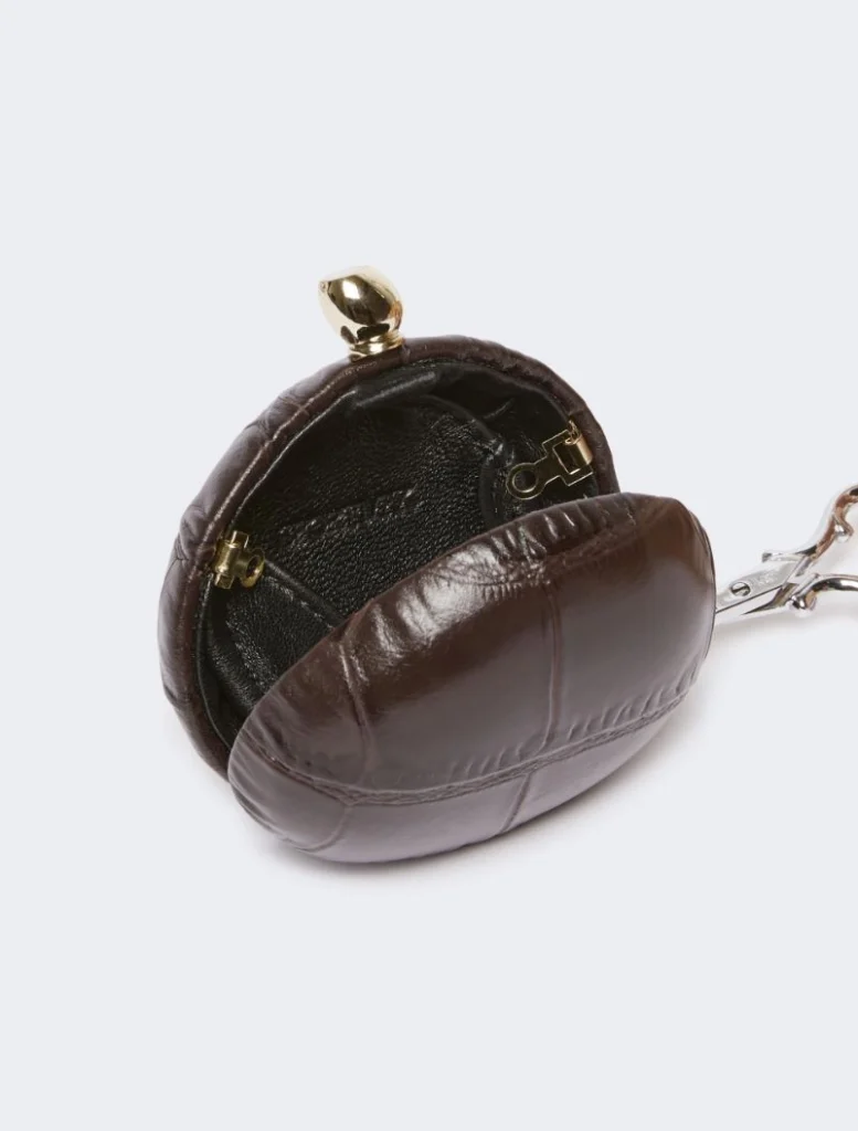 Brown round brown leather coin purse with a gold kiss-lock clasp and keychain attachment on the side.