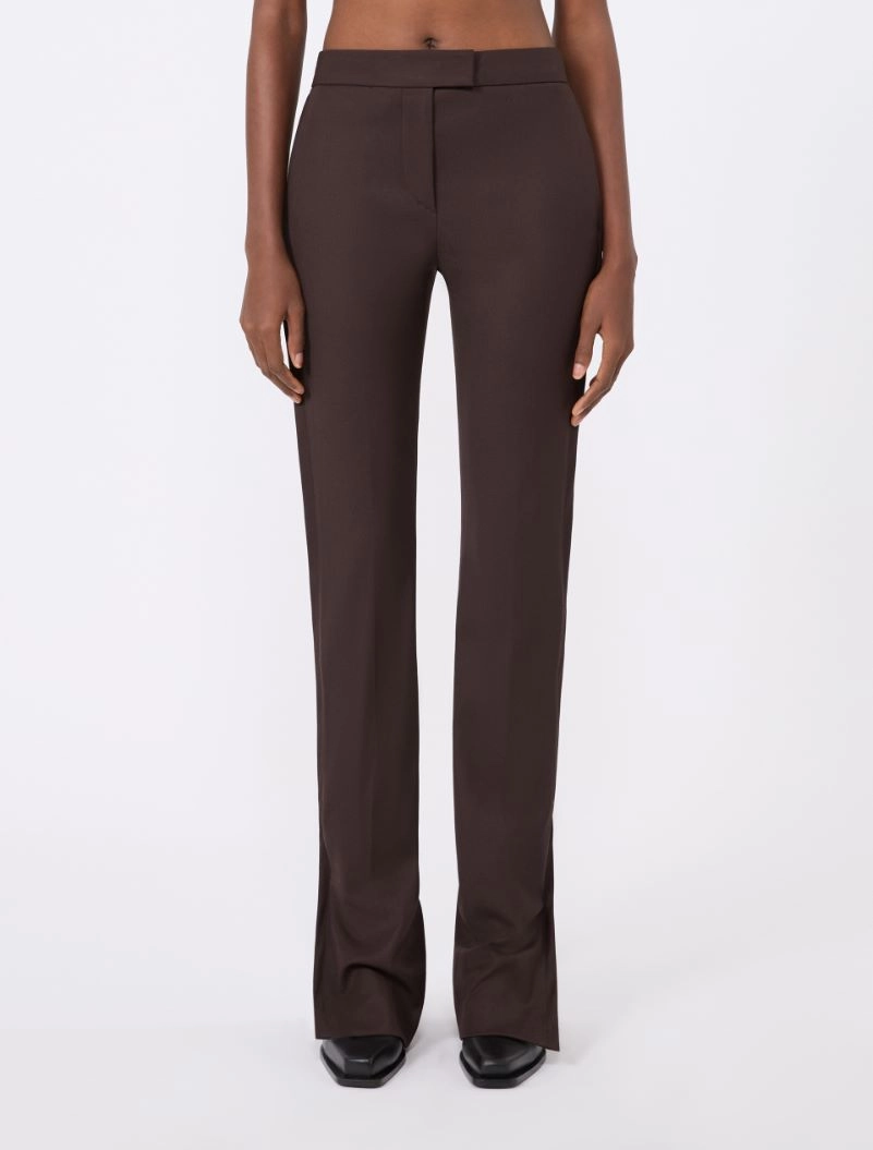 IMG_3875 - New Trend Full-length view of a person wearing dark brown, high-waisted wide-leg trousers with a matching belt, standing facing forward in black shoes.