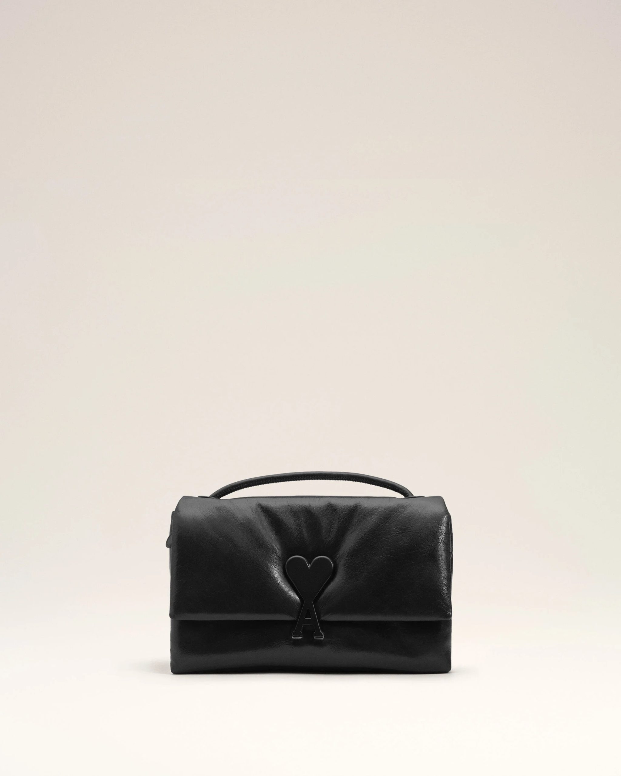 Image 108 - New Trend Black leather handbag with a heart-shaped clasp displayed on a pale studio background.