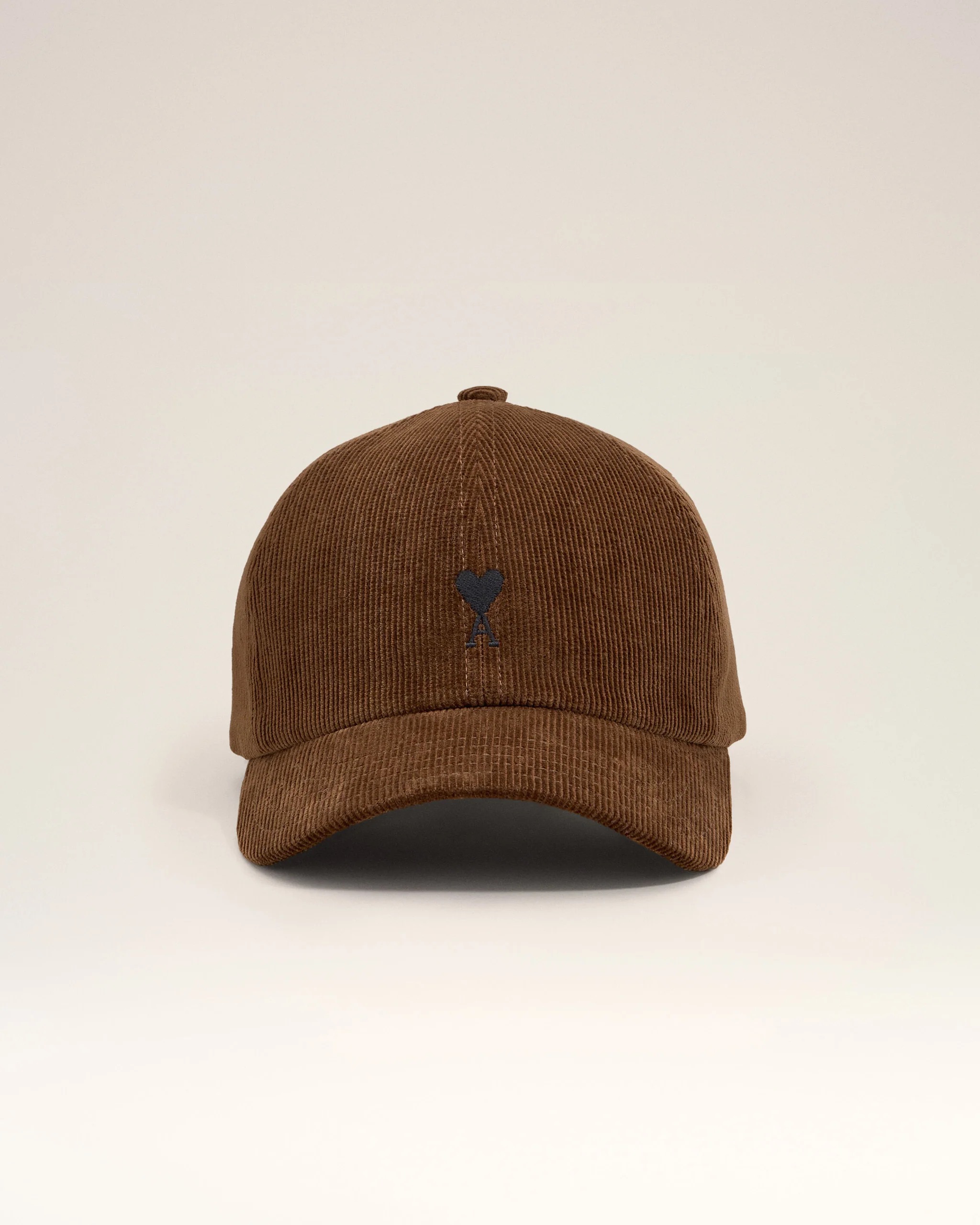Image 121 - New Trend Brown corduroy baseball cap viewed from above with a small dark emblem on the front panel against a pale background,