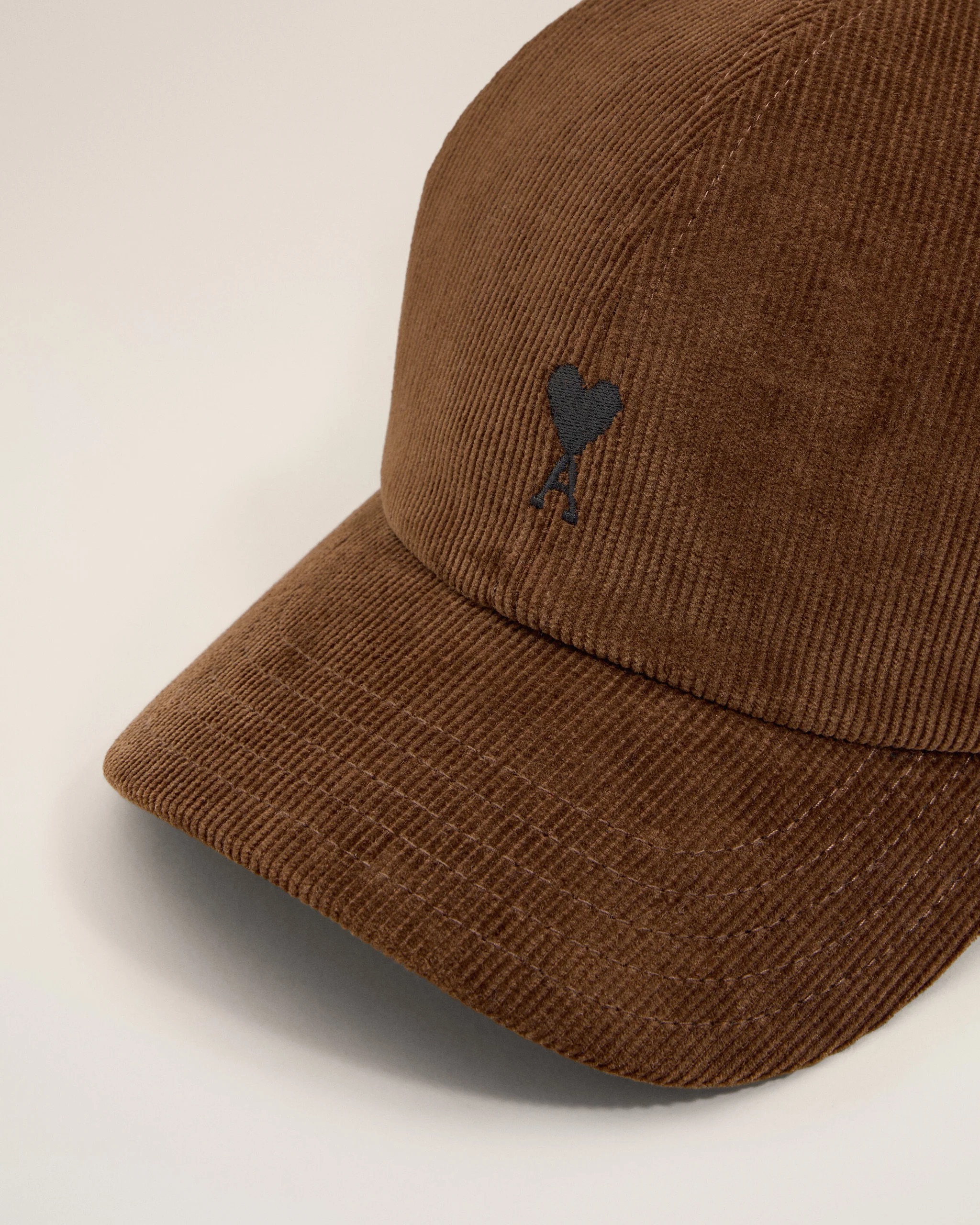 Image 122 - New Trend Close-up of a brown corduroy hat with a small black heart emblem on the side