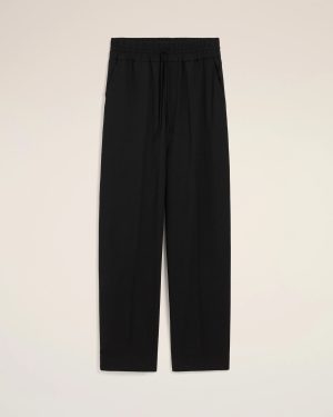 Black trousers with an elastic drawstring waistband and side pockets, shown from the waist to mid-thigh against a light background.