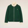 Green zip-up jacket with cream ribbed collar and cuffs, small white heart emblem on the left chest.