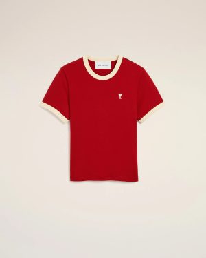 Red short-sleeve T-shirt with cream trim at the collar and cuffs, featuring a small white heart-and-A logo on the left chest against a light background.