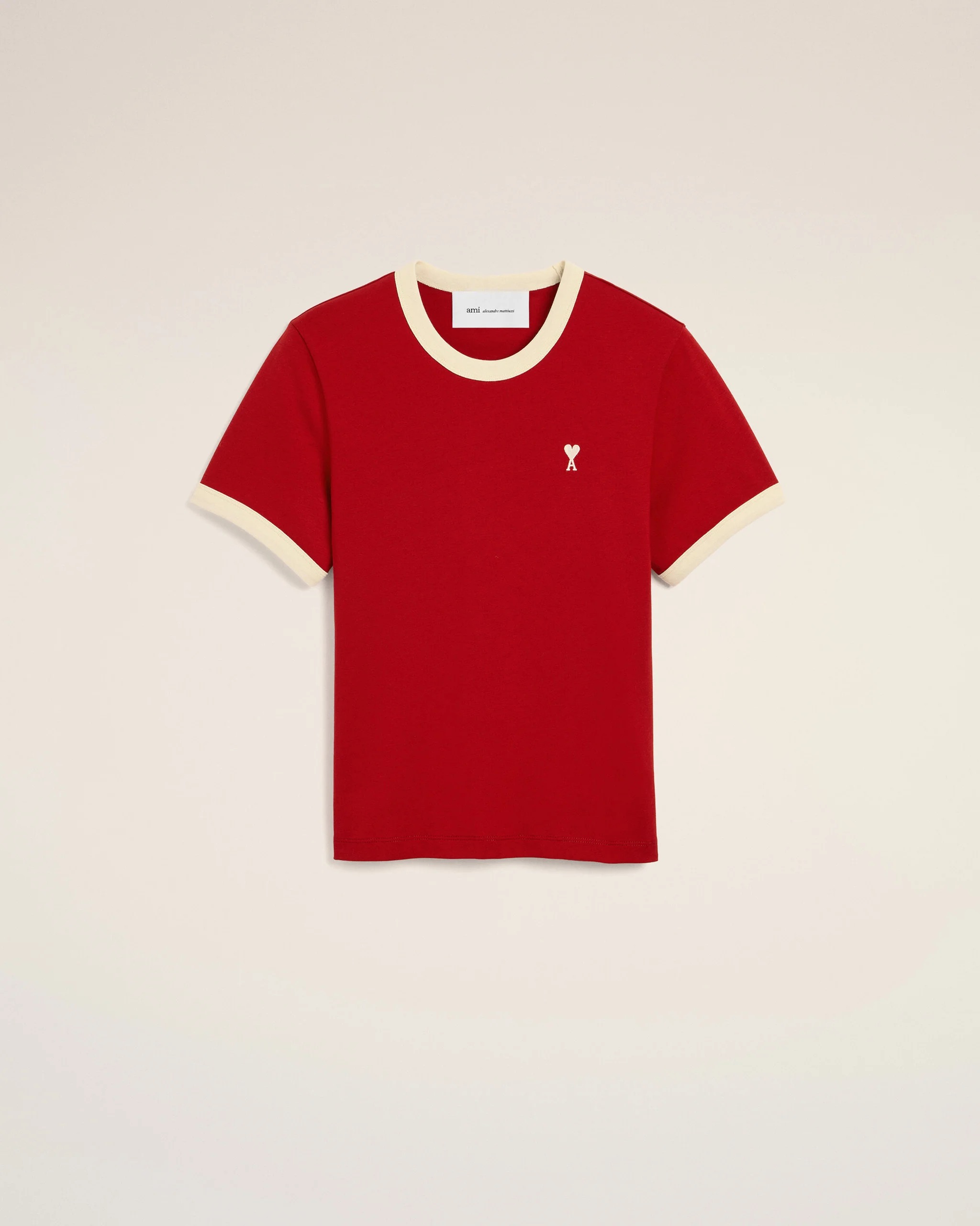 Image 158 - New Trend Red short-sleeve T-shirt with cream trim at the collar and cuffs, featuring a small white heart-and-A logo on the left chest against a light background.