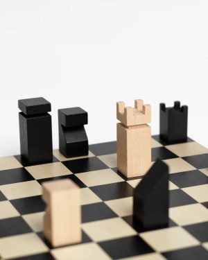 Wooden chess pieces on a black-and-cream checkered board, with a light piece surrounded by dark pieces in the foreground.
