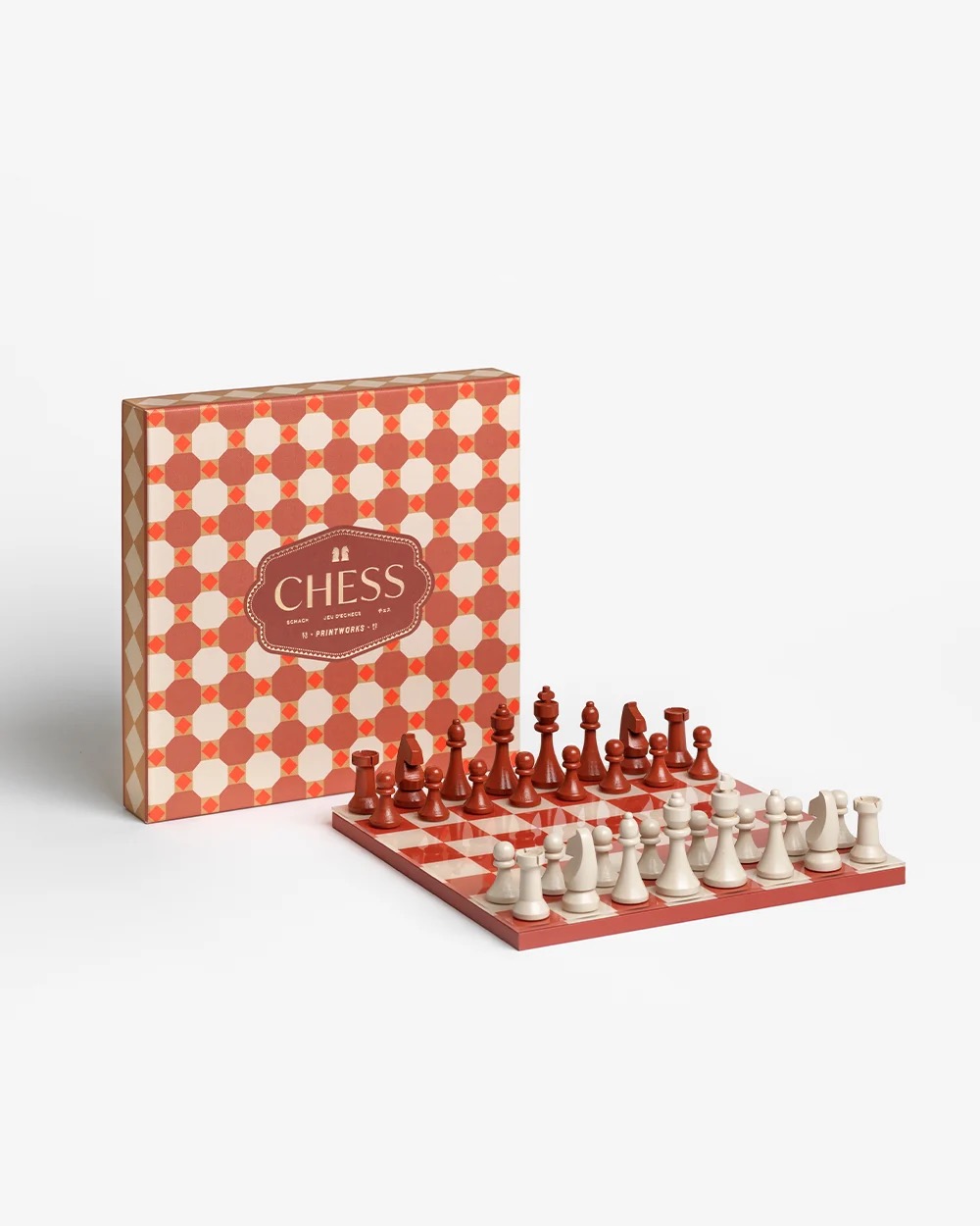Image 187 - New Trend Red and white chess set with a geometric patterned box; red and white pieces arranged on a checkerboard.