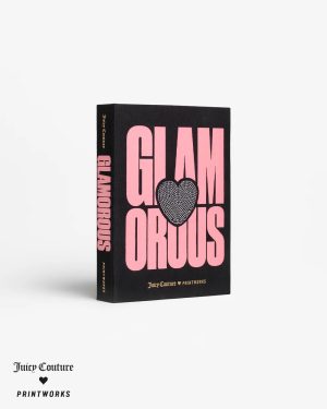 Black book with bold pink 'GLAMOROUS' lettering and a heart motif on the front, spine reads 'GLAMOROUS', white background; bottom left shows 'Juice Couture' and 'PRINTWORKS' logos.