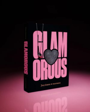 Black fashion book titled GLAMOROUS in bold pink letters with a rhinestone heart and a necklace draped over the cover.