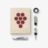 Beige wine-themed gift box with a grape cluster graphic, surrounded by wine accessories: corkscrew, foil cutter, pour spout, stopper, and wand tool.
