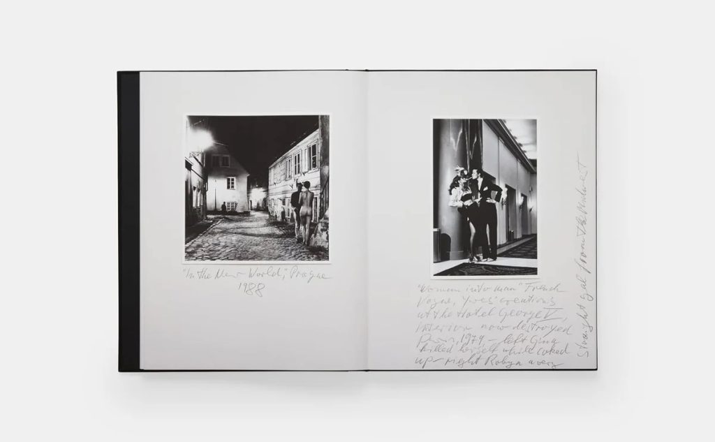 Open photo book with two black-and-white images: a nighttime street scene on the left showing a couple walking, and a couple in a hallway on the right, with handwritten captions around both images.