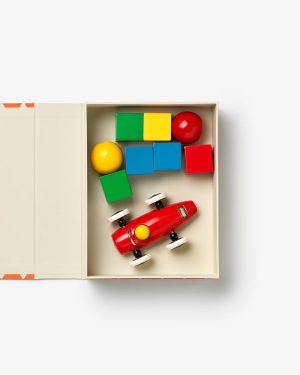 Open white box with colorful wooden blocks (green, yellow, blue, red) and a red toy car.