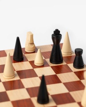 Close-up of a wooden chessboard with black and light-colored pieces arranged mid-game on alternating squares in a white background setting