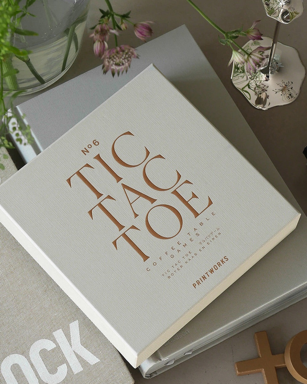Image 241 - New Trend White textured book titled 'No.6 Coffee Table' in copper letters on a table with flowers and a decorative lamp nearby.