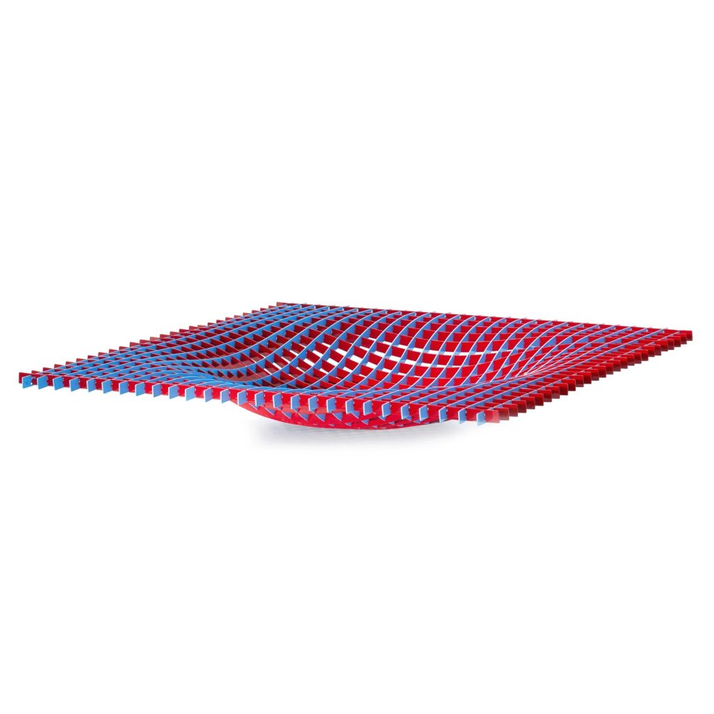 Red and blue interlocking lattice strips form a wavy grid on a white background, creating a curved geometric surface.