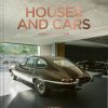 Poster showing a vintage car inside a modern showroom with a coral title reading 'HOUSES AND CARS' across the top and a small author line underneath.
