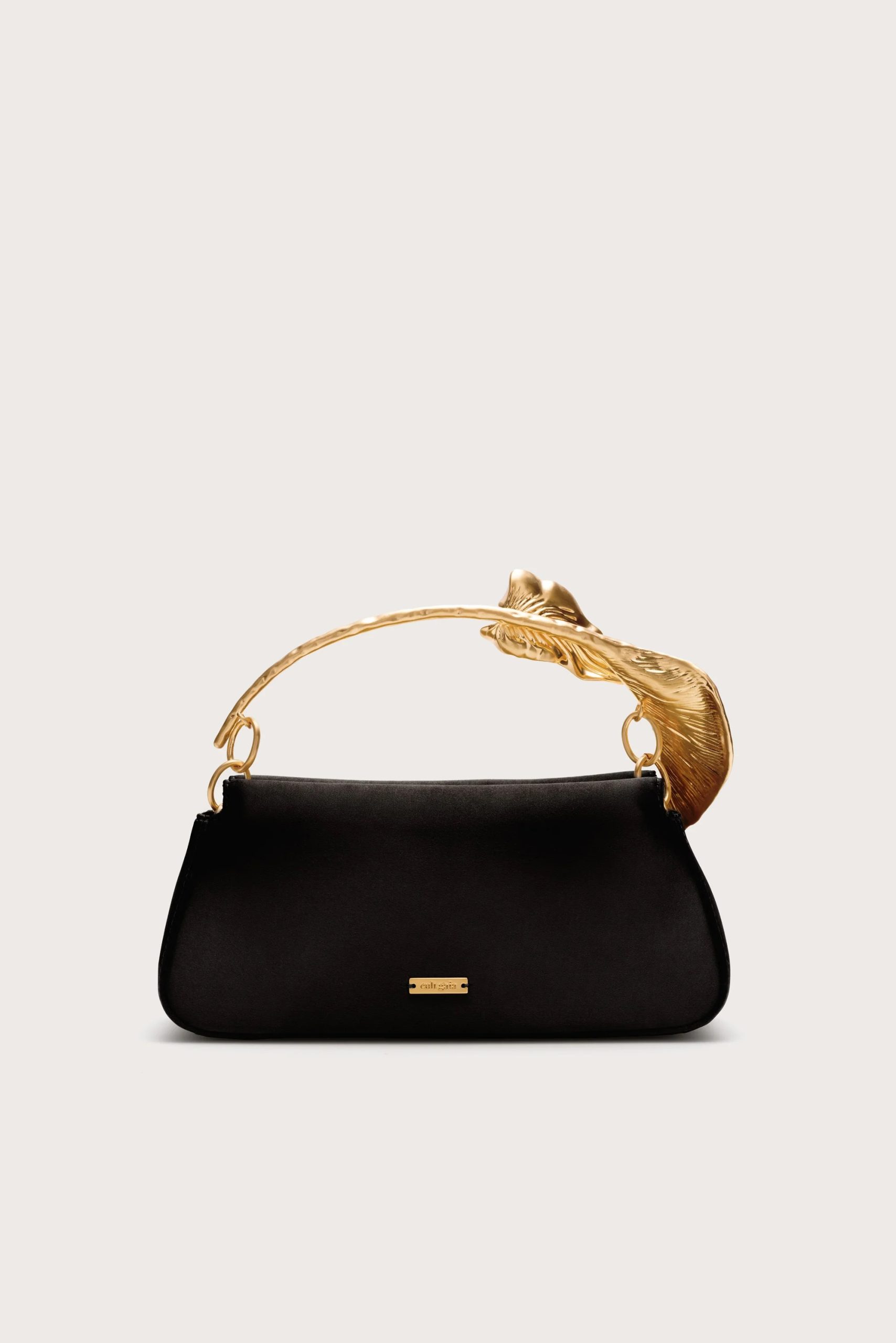 Image 426 - New Trend Black handbag with a gold curved handle and small gold logo plate, set against a pale beige background.
