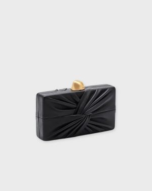 Black rectangular clutch purse with twisted fabric knot and gold top clasp, elegant evening accessory.