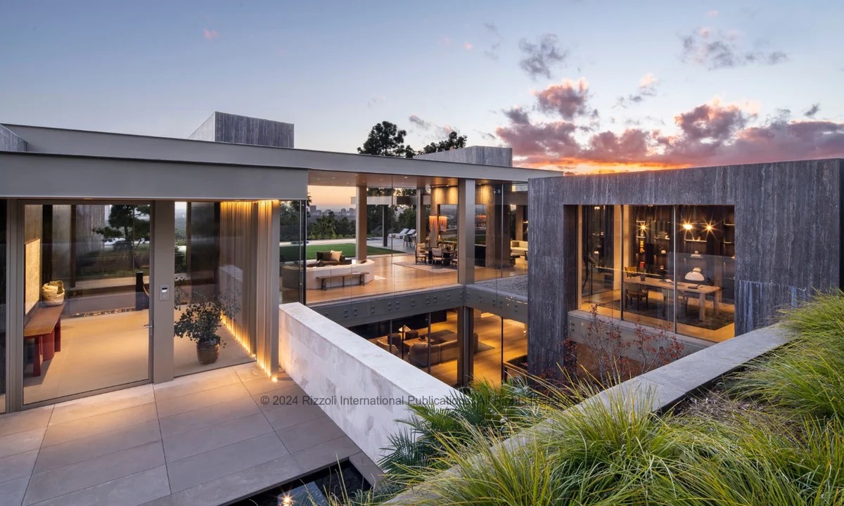 Image 46 - New Trend Modern villa with glass walls and warm interior lighting overlooking a sunset sky as the day ends.