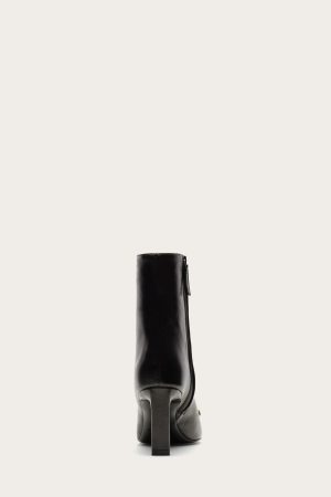 Back view of a black leather knee-high boot with a chunky heel.