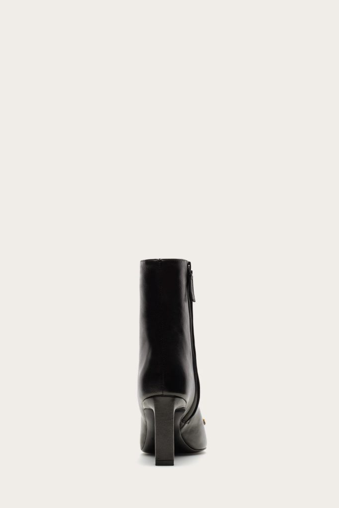 Back view of a black leather knee-high boot with a chunky heel.