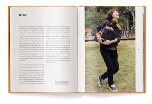 Open book spread with text on the left; a joyful woman outdoors on the right, holding a black handbag and a book.
