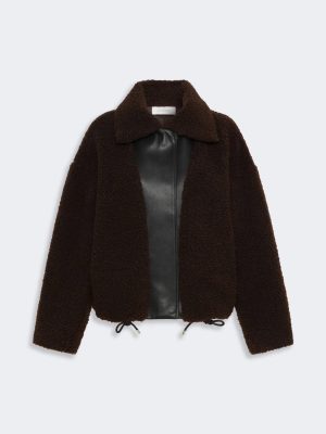 Brown teddy-bear fleece coat with a black leather front panel and drawstring hem.