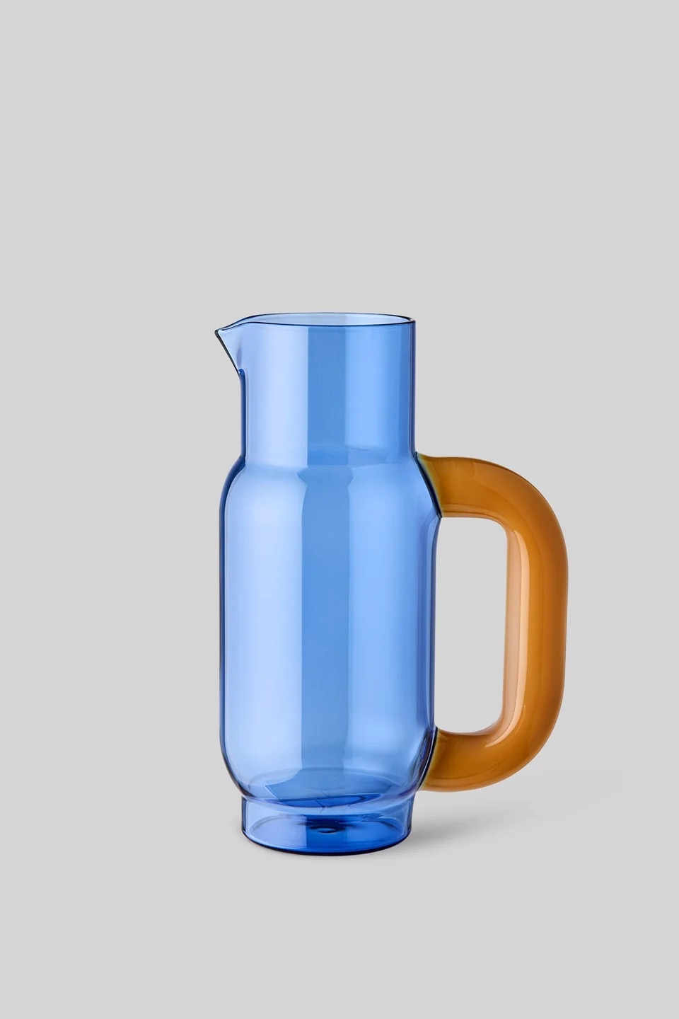 Image 570 - New Trend Blue glass pitcher with an amber-orange handle on a light gray background, viewed from the side.