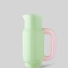 Image 578 - New Trend Pastel green pitcher with a pink translucent handle on a gray background for pouring drinks.