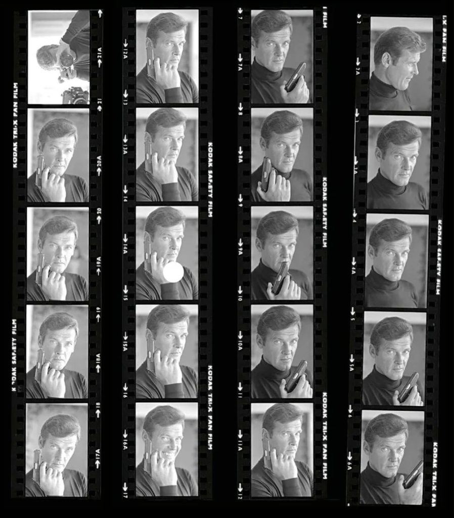 A black-and-white strip of film frames showing a man posing with a mobile phone in various positions, like talking, holding, and thinking, arranged in four vertical columns.