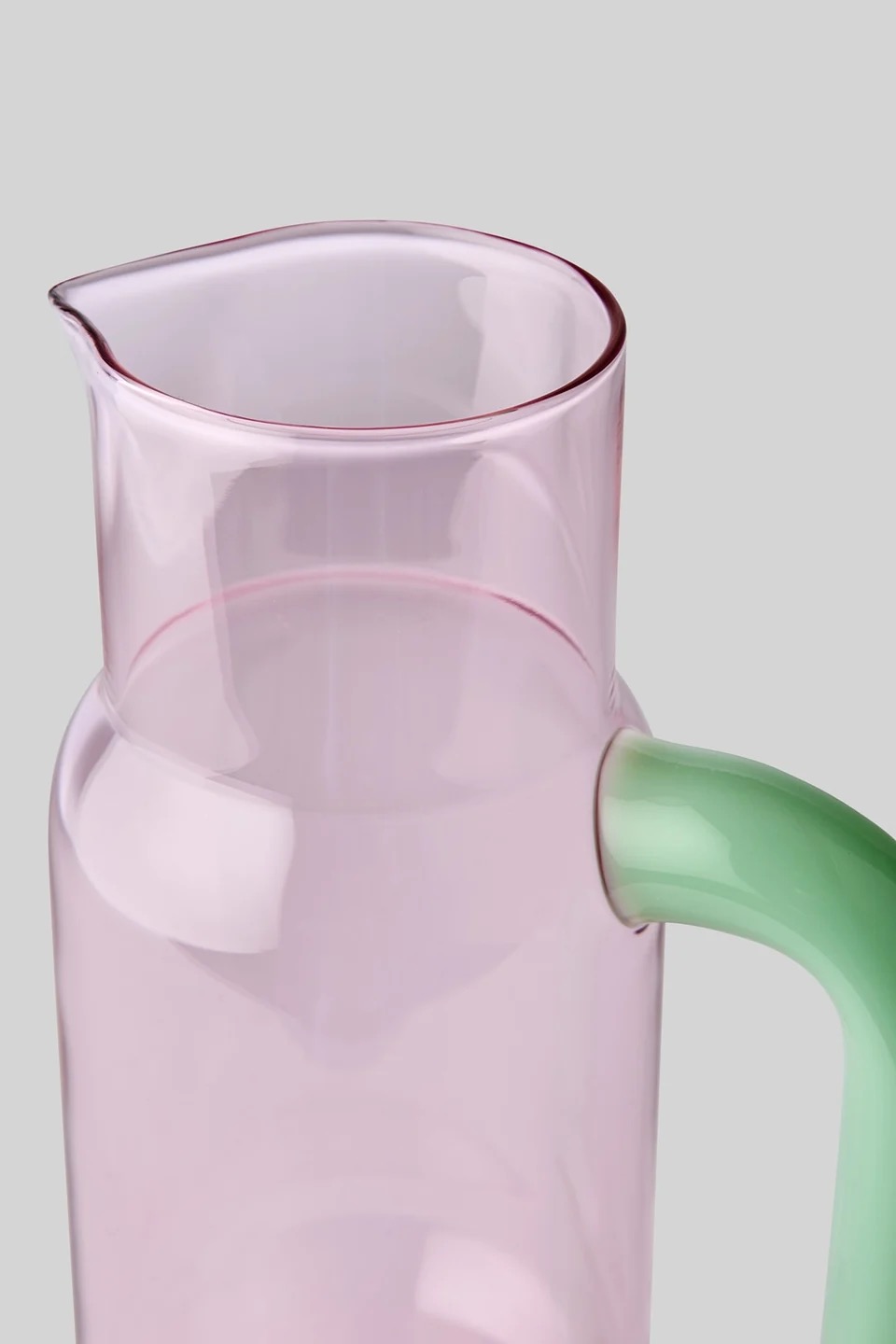 Image 589 - New Trend Pink translucent glass pitcher with a pale green handle against a neutral gray background.