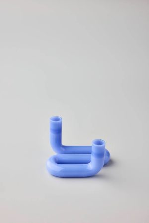 Glossy blue silicone sculpture with two curved tubular arms forming a rounded, open loop.
