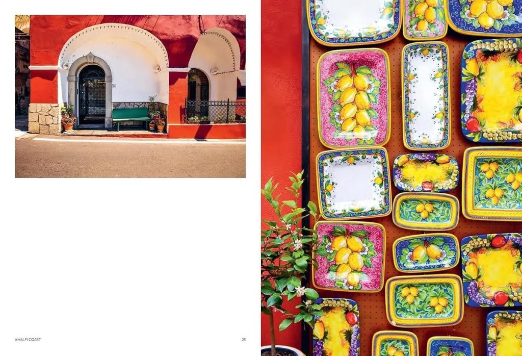 Spread shows a white arched building with red walls on the left and a wall of colorful lemon-patterned ceramic trays on the right.