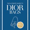 Blue book cover titled 'The Ultimate Guide to Dior Bags' by Alexandra Fullerton, with a simple handbag outline and a gold Brand Bible badge.