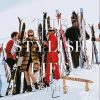 Group of skiers in winter gear standing in the snow with skis upright, magazine title 'The Style Life' overlaid on the image.